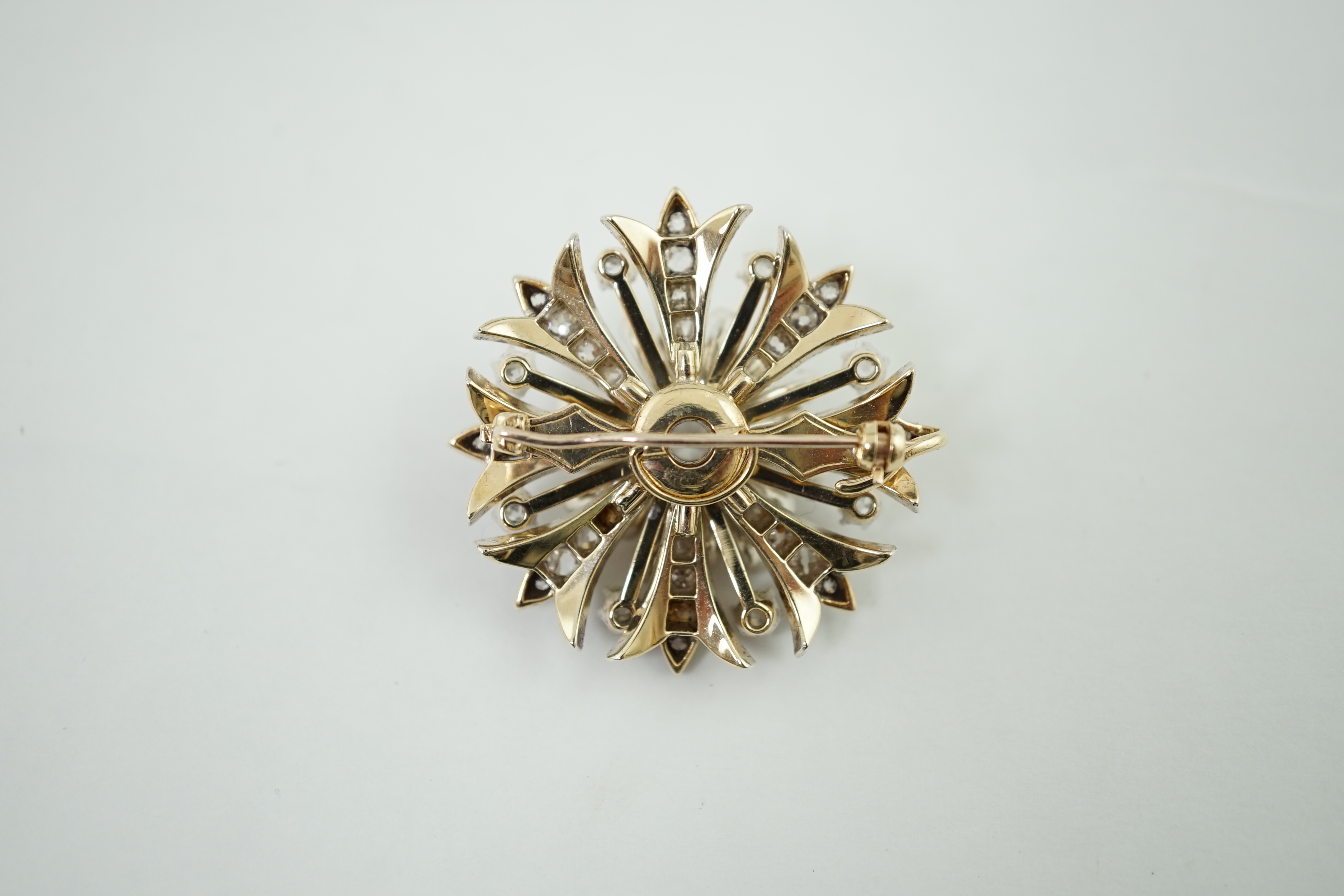 A late Victorian gold and diamond foliate starburst pendant brooch